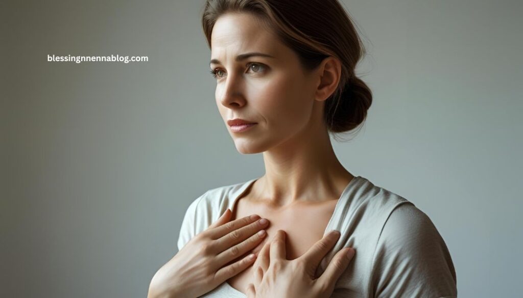 A woman holding her chest, looking reflective