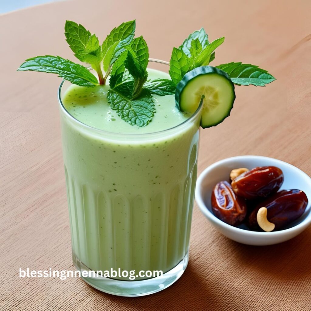 A chilled glass of cucumber smoothie with mint leaves, served on a table with a small bowl of dates  beside it.